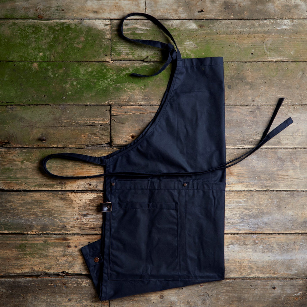 Dark blue wax cotton, dark blue outdoor apron, BBQ apron, barbecue apron, apron for men, masculine apron, hardwearing apron UK, comfortable outdoor apron UK, handmade waxed cotton apron, utility ware, quality outdoor aprons